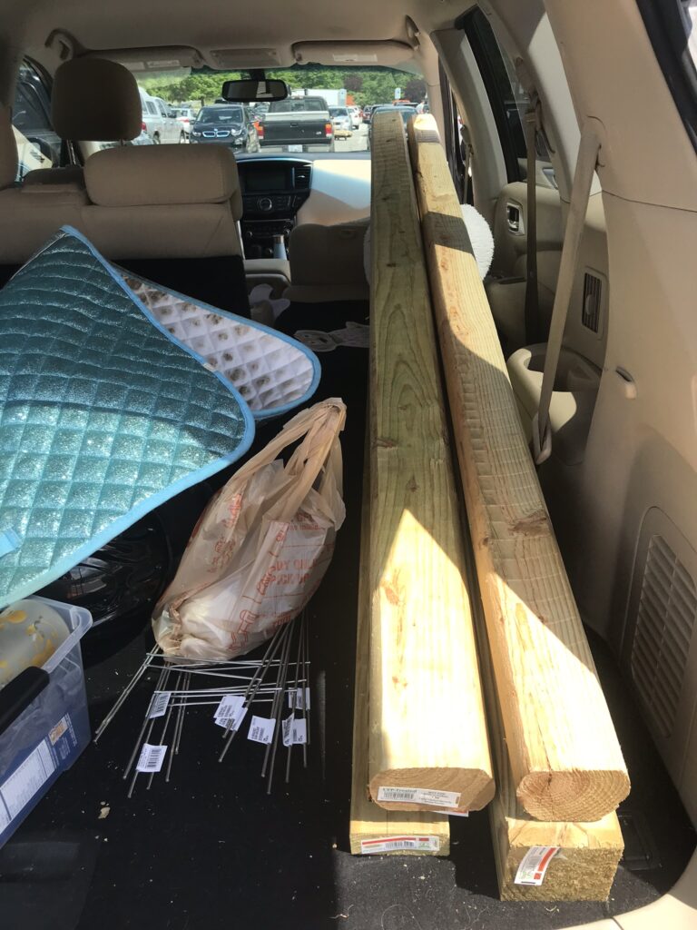 supplies for DIY horse show jump loaded into back of SUV